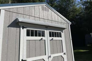 DOORBRIM rain guard mounted above shed double doors to stop leaks.