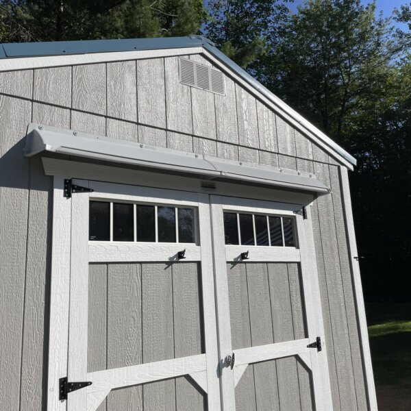 DOORBRIM rain guard mounted above shed double doors to stop leaks.