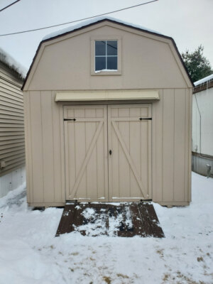 DOORBRIM rain diverter mounted above double shed doors.