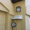 Off white door canopy mounted over a mustard color electric service panel.