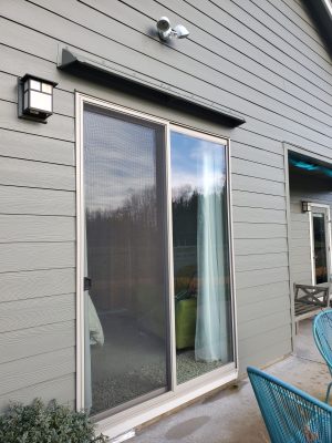 Gray DOORBRIM over door awning above a living glass door.