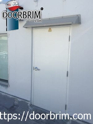 Doorbrim rain diverter mounted over roof access door.