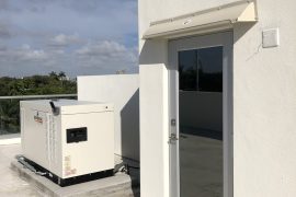 Doorbrim rain diverter mounted over roof access door.