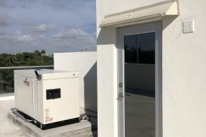 Doorbrim rain diverter mounted over roof access door.