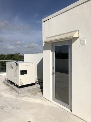 Doorbrim rain diverter mounted over roof access door.