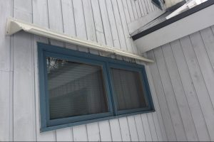 DOORBRIM rain guard mounted above an exterior window to stop leaking.