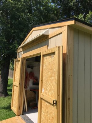 DOORBRIM over door rain diverter mounted above double shed doors.