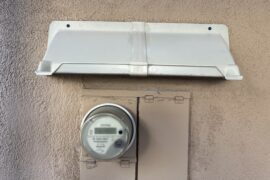 Rain hood above electric service box.