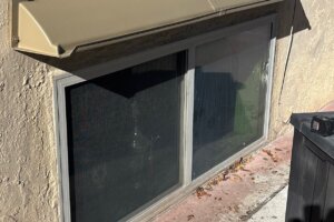 Doorbrim wall mount rain diverter above cellar window.