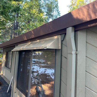 Doorbrim rain diverter mounted above a horizontal sliding window.