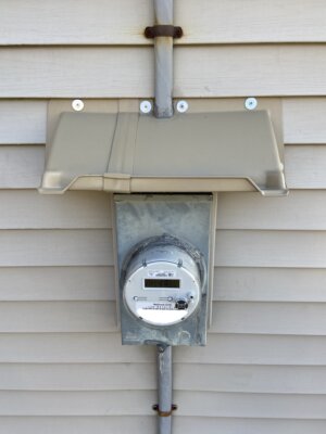 Doorbrim with offset center bracket to accommodate cable above a electric service meter box